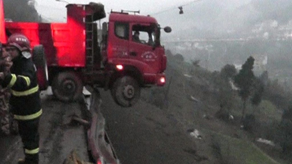 Family rescued from dangling cliff-edge truck