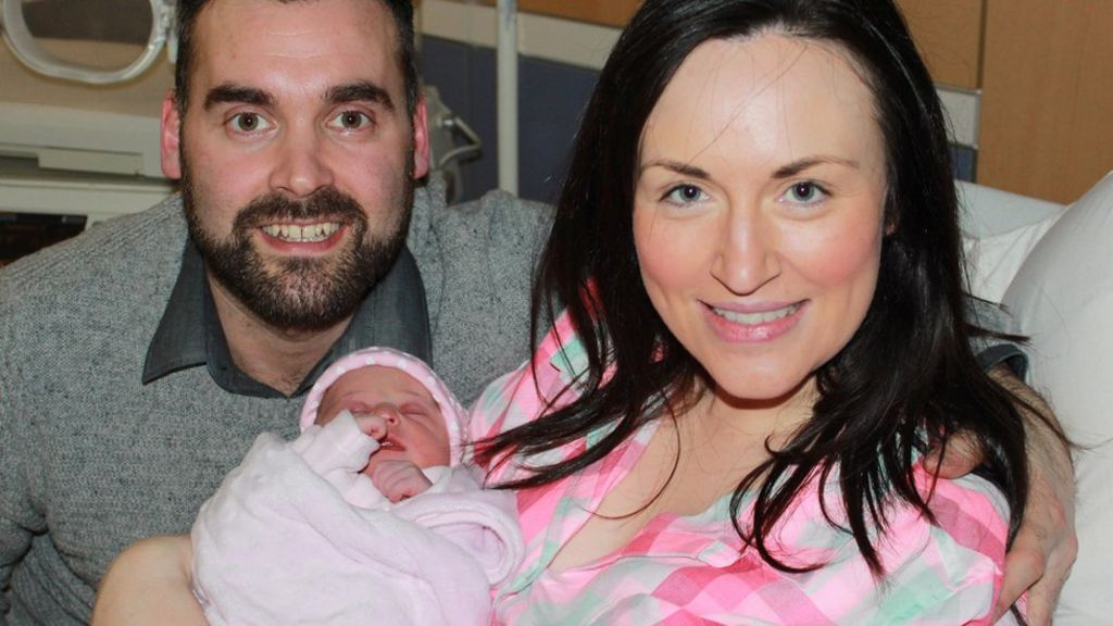 Father ties baby's umbilical cord with shoelaces