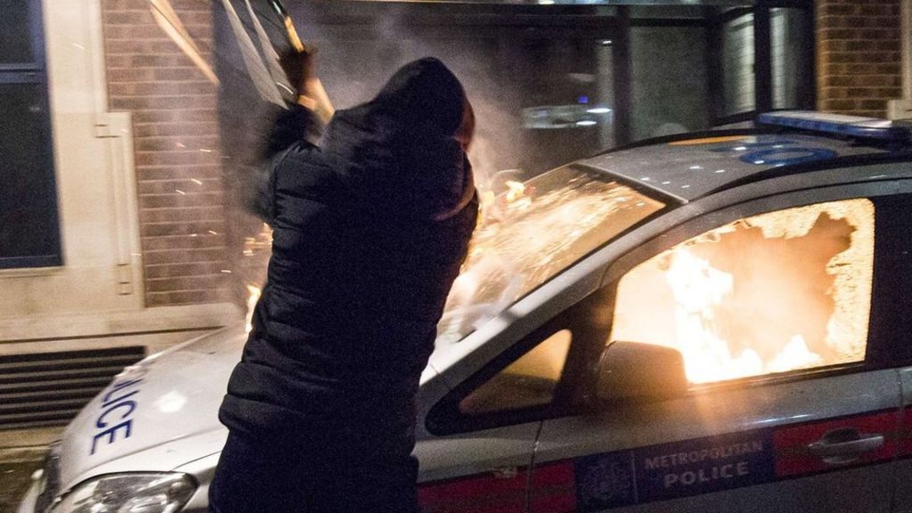 Police car set alight at London demo