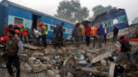 Rescue workers search for survivors at the site of Sunday"s train derailment in Pukhrayan, south of Kanpur city, India November 21, 2016.