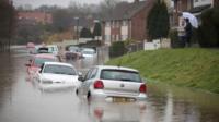 Cars are abandoned in Hartcliffe,, Bristol, after heavy rain fall flooded the street, 21 November 2016.