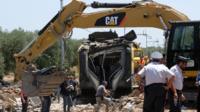 Officials inspect wreckage from train crash near Andria (13 July)