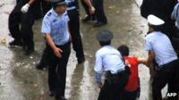 Police arrest protester in Lichuang, Hubei province, during a violent demonstration sparked by the alleged death of a local legislator (June 2011)