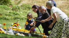 People lay flowers at the 7/7 Hyde Park memorial