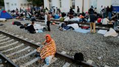 Migrants and refugees gather along the tracks at the train station in Tovarnik, Croatia, 19 September 2015