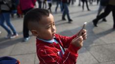 Chinese boy using smartphone