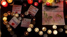 Burning candles, messages and a drawing pay tribute to victims of the truck attack along the Promenade des Anglais on Bastille Day that killed scores and injured as many in Nice, France, 17 July 2016.