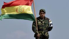 A Bolivian soldier holds the national flag during the inauguration of the new military academy August 17, 2016