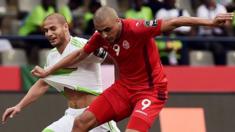 Tunisia's forward Ahmed Akaichi (right) challenges Algeria's midfielder Adlene Guedioura