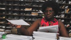 A post office employee in Abidjan sorting mail, Ivory Coast