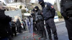 Flowers are placed next to Turkish police officers as they stand guard near the Reina nightclub, which was attacked by a gunman, in Istanbul, Turkey, on 1 January 2017