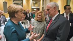 A handout photo made available by the press office of the German government (BPA) shows German Chancellor Angela Merkel (L) and US Vice President Michael Pence (R) having a chat during the 53rd Munich Security Conference (