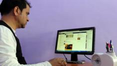 A Kashmiri man looks at the social networking site Facebook