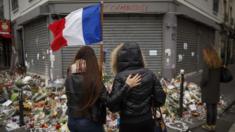 Two women stand outside Le Petit Cambodge restaurant, one of those targeted in the attacks