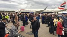 Passengers outside the terminal building and grounded flights at London City Airport