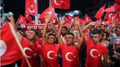 Supporters of Turkish President Recep Tayyip Erdogan shout slogans against the failed coup attempt as they hold Turkish flags, during a demonstration at Taksim Square in Istanbu, Turkey, 22 July 2016