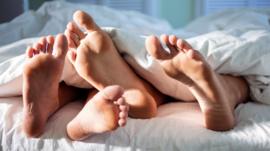 Detail of feet in a bed