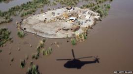 Villagers gather to seek higher ground in the Rajanpur district, in Punjab province