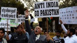 A file picture taken on February 17, 2016 shows Indian activists shouting slogans against Jawaharlal Nehru University (JNU) and the late Kashmiri separatist Mohammed Afzal Guru at a protest outside the university in New Delhi.