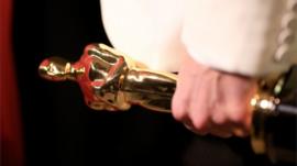 Hand holding an Oscar