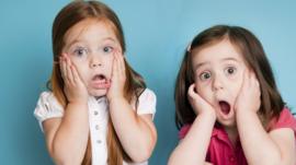 Pair of little girls looking shocked