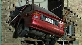 Car embedded in house