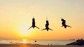 Three pogo-ers upside down