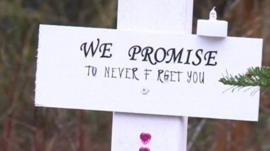 Grave marker saying 'We promise to never forget you'