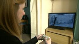 Woman playing on a games console