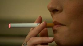 A woman smoking an electronic cigarette