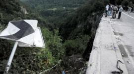 People look at the scene of a bus accident near Grlo
