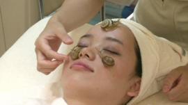 A woman having a snail facial