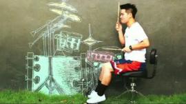A Thai musician air drumming