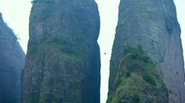 Wingsuit dive through narrow crevasse
