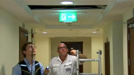 Men inspect hole in ceiling