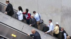 People exit a Metro subway station, by escalator, along Pennsylvania Ave., NW, in Washington, Thursday, Oct. 17, 2013