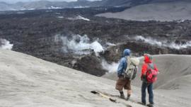 Researchers watch the obsidian flow at Cordon Caulle volcano in Chile