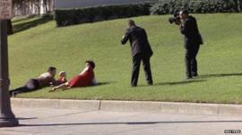 Bill and Gayle Newman covering their children after shots were fired at President Kennedy