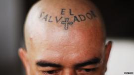 A man with a tattoo on his forehead reading