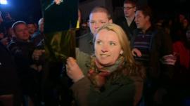 Woman in Sevastopol holding up Ukrainian colours