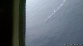 Footage from the Royal Australian Air Force P-3 Orion aircraft shows a smoke marker next to one of the objects
