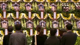 Photographs of victims at a memorial service