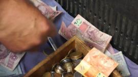 Money in a till in a Sao Paulo market
