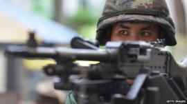 Thai army soldier stands guard on a city centre street after martial law was declared, Bangkok, Thailand, 20 May 2014