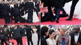 Vitalii Sediuk blocked by minders as he tries to get under US actress America Ferrera's dress as she arrives for the screening of the animated film How to train your Dragon 2 at the 67th edition of the Cannes Film Festival in Cannes, southern France, on May 16 2014
