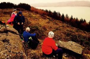 Women rest near a lake