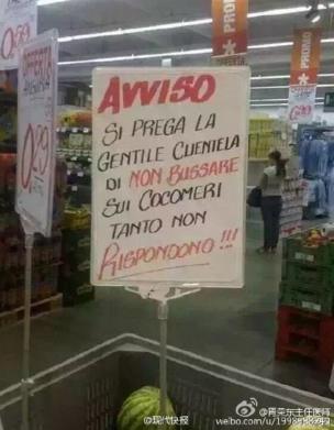 Photo of a sign in an Italian supermarket, placed in a cart full of watermelons. Translated from Italian it reads: 