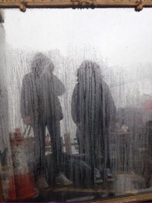 Two figures in the rain