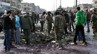 Syrians look at a crater caused by a bombing in Syria
