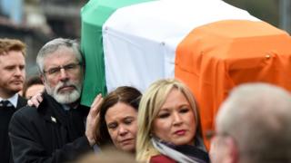 Sinn Féin President Gerry Adams, Sinn Féin southern leader Mary Lou McDonald and Northern Ireland leader Michelle O'Neill carry the coffin of the late Martin McGuinness as the funeral cortege passes through the streets of Derry on 23 March 2017